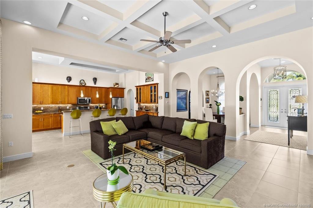 4940 Southeast Inlet Isle Way Stuart, FL 34997 - Photo 13 of 75 a living room with furniture kitchen view and a chandelier