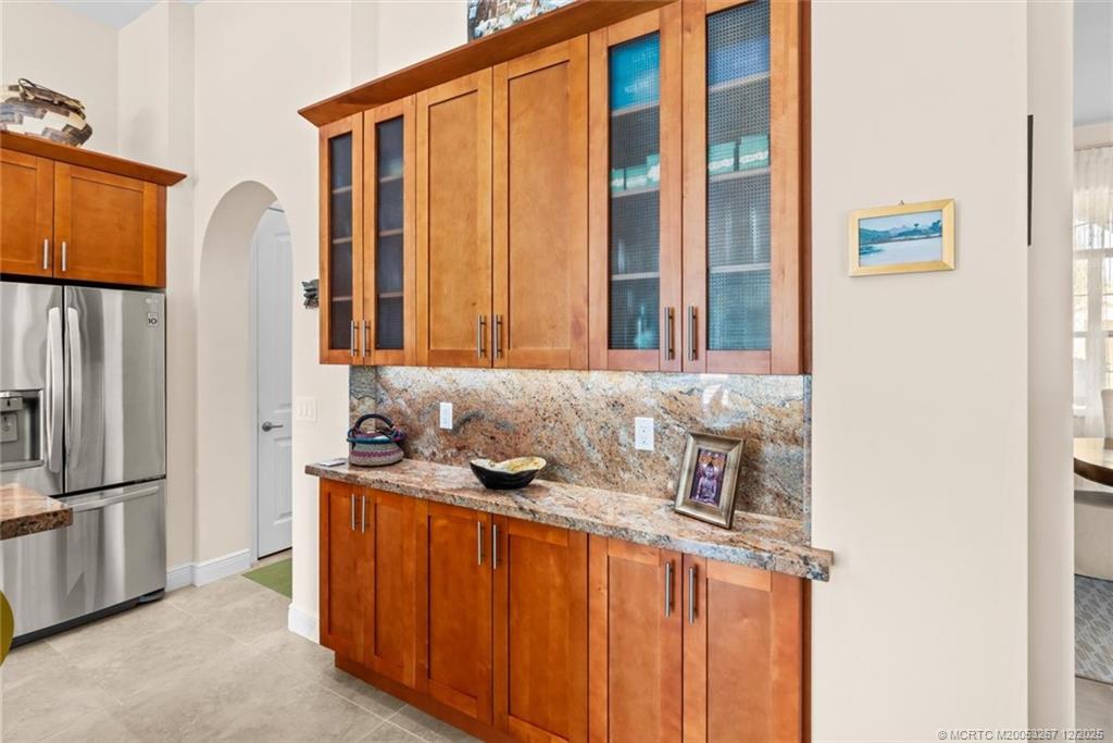 4940 Southeast Inlet Isle Way Stuart, FL 34997 - Photo 19 of 75 a bathroom with a sink and a mirror