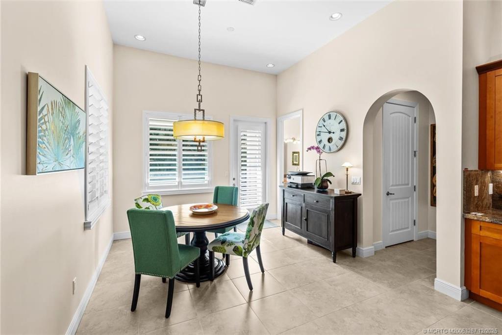 4940 Southeast Inlet Isle Way Stuart, FL 34997 - Photo 23 of 75 a view of a dining room with furniture and a window