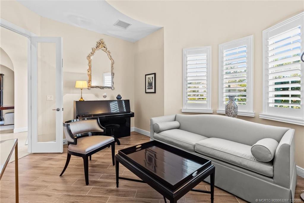4940 Southeast Inlet Isle Way Stuart, FL 34997 - Photo 26 of 75 a living room with furniture and a large window