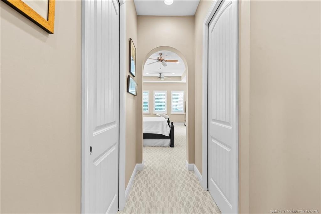 4940 Southeast Inlet Isle Way Stuart, FL 34997 - Photo 27 of 75 a view of a hallway view with wooden floor and a bathroom