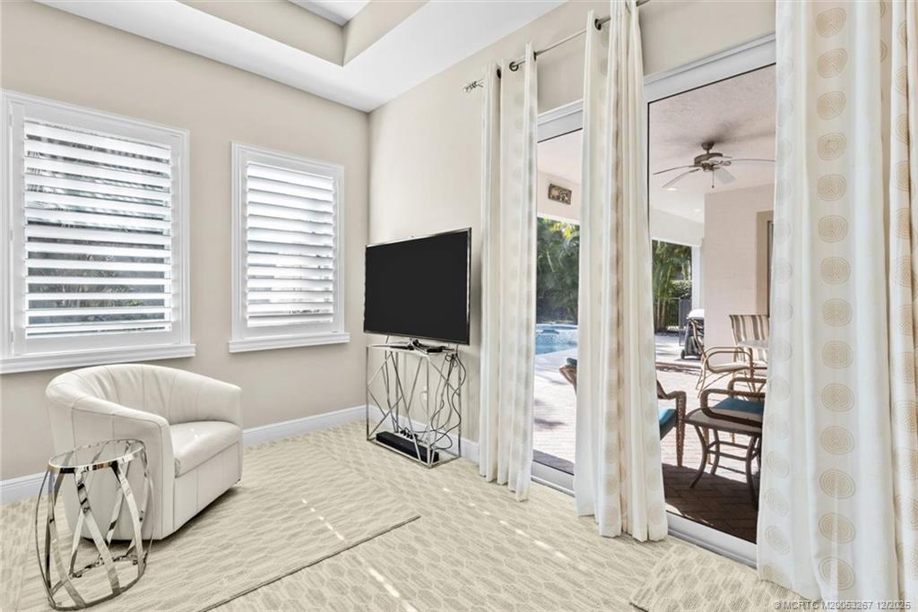 4940 Southeast Inlet Isle Way Stuart, FL 34997 - Photo 30 of 75 a living room with furniture and a flat screen tv