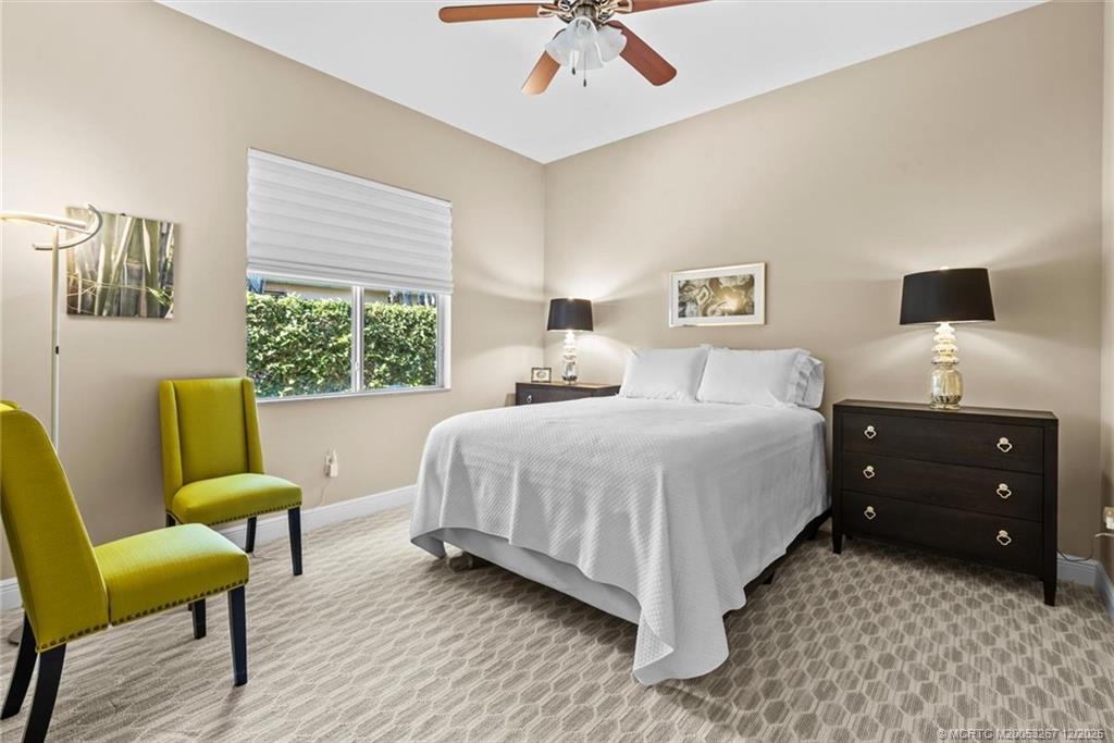 4940 Southeast Inlet Isle Way Stuart, FL 34997 - Photo 36 of 75 a bedroom with a bed and a chair