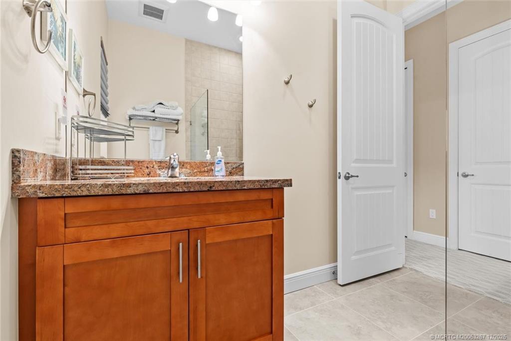 4940 Southeast Inlet Isle Way Stuart, FL 34997 - Photo 39 of 75 a bathroom with a sink and a mirror