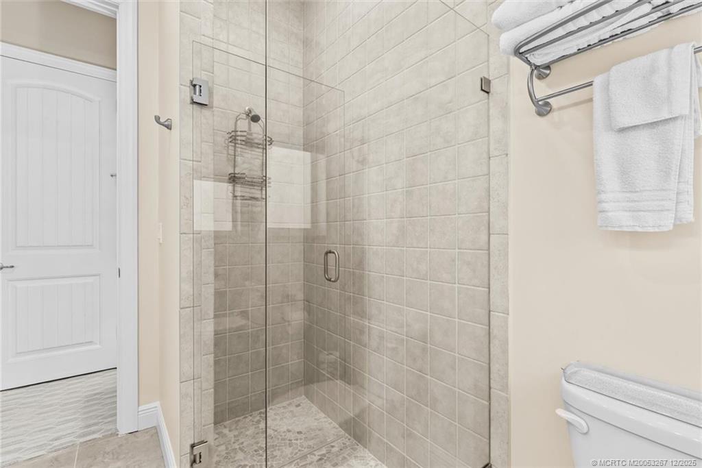 4940 Southeast Inlet Isle Way Stuart, FL 34997 - Photo 40 of 75 a bathroom with a shower and a toilet
