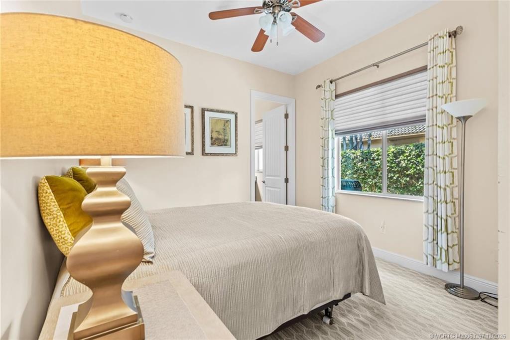 4940 Southeast Inlet Isle Way Stuart, FL 34997 - Photo 43 of 75 a bedroom with a bed and wooden floor