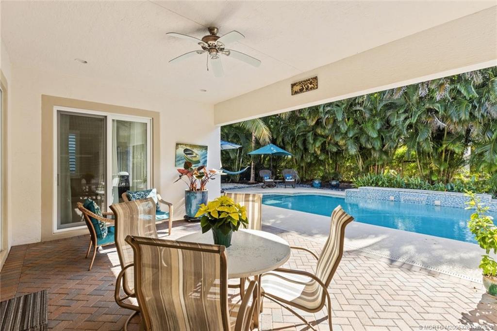 4940 Southeast Inlet Isle Way Stuart, FL 34997 - Photo 45 of 75 a view of a dining room with furniture a rug and wooden floor