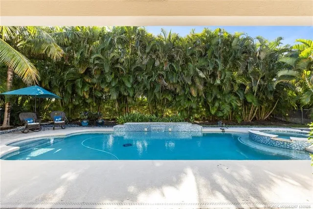 an aerial view of residential houses with outdoor space and swimming pool