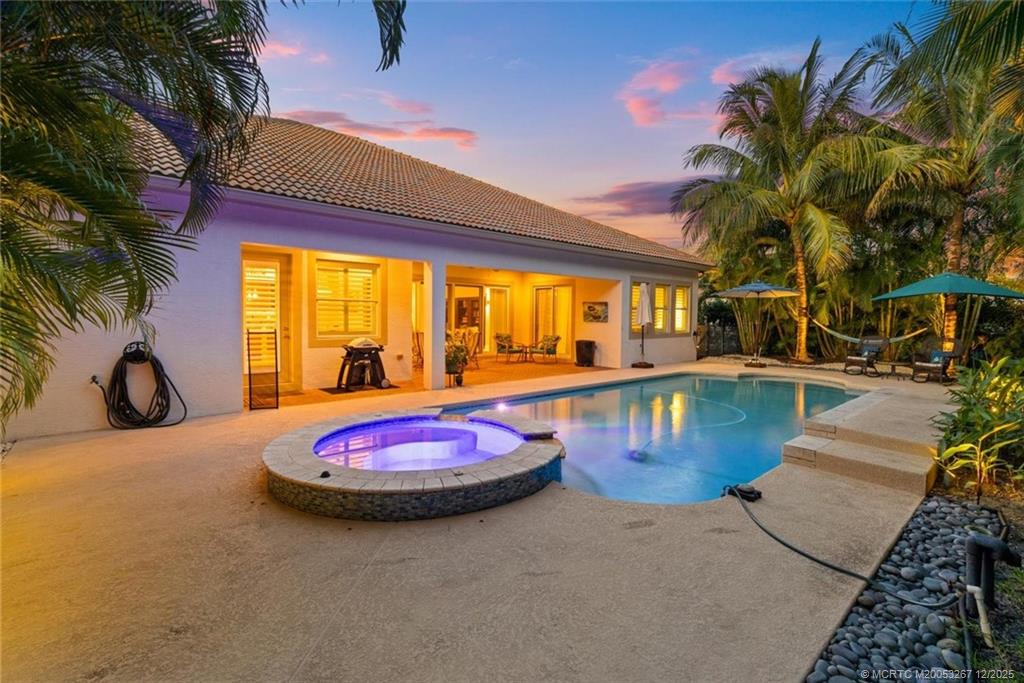 4940 Southeast Inlet Isle Way Stuart, FL 34997 - Photo 55 of 75 a view of a swimming pool with an outdoor seating