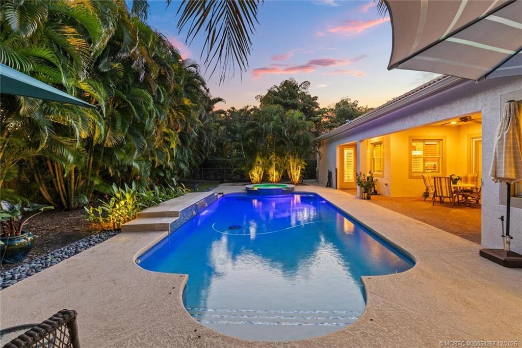 4940 Southeast Inlet Isle Way Stuart, FL 34997 - Photo 60 of 75 a view of a swimming pool with a yard