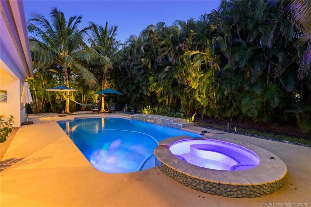 4940 Southeast Inlet Isle Way Stuart, FL 34997 - Photo 62 of 75 a view of a swimming pool with a patio