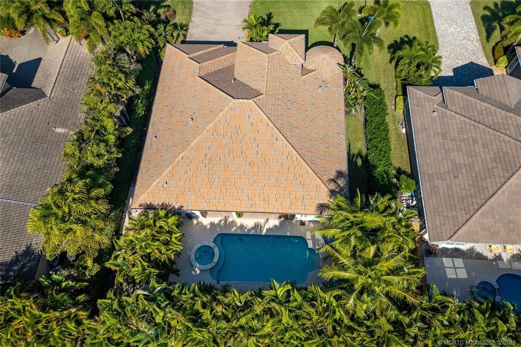 4940 Southeast Inlet Isle Way Stuart, FL 34997 - Photo 65 of 75 an aerial view of a house with a yard and garden