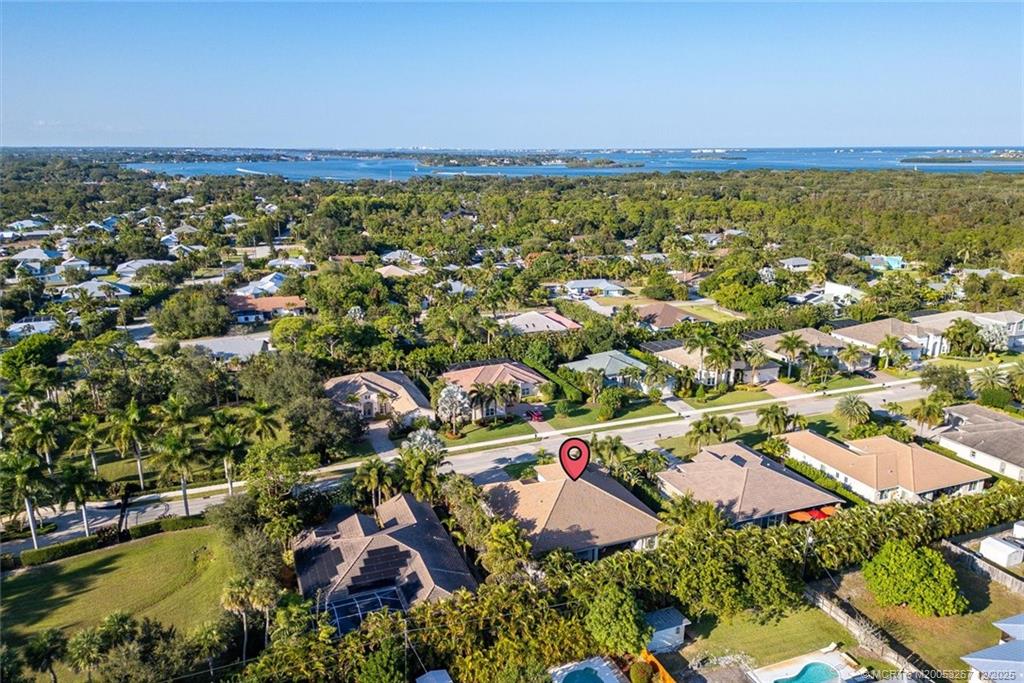 4940 Southeast Inlet Isle Way Stuart, FL 34997 - Photo 70 of 75 an aerial view of residential houses with outdoor space and swimming pool