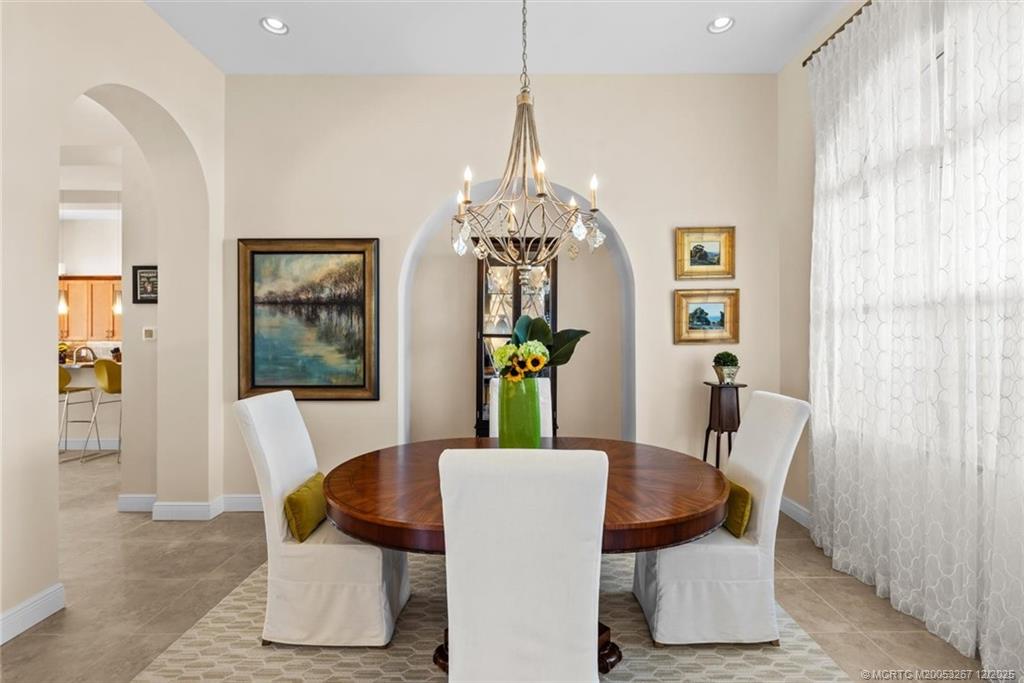 4940 Southeast Inlet Isle Way Stuart, FL 34997 - Photo 9 of 75 a dining room with furniture and window