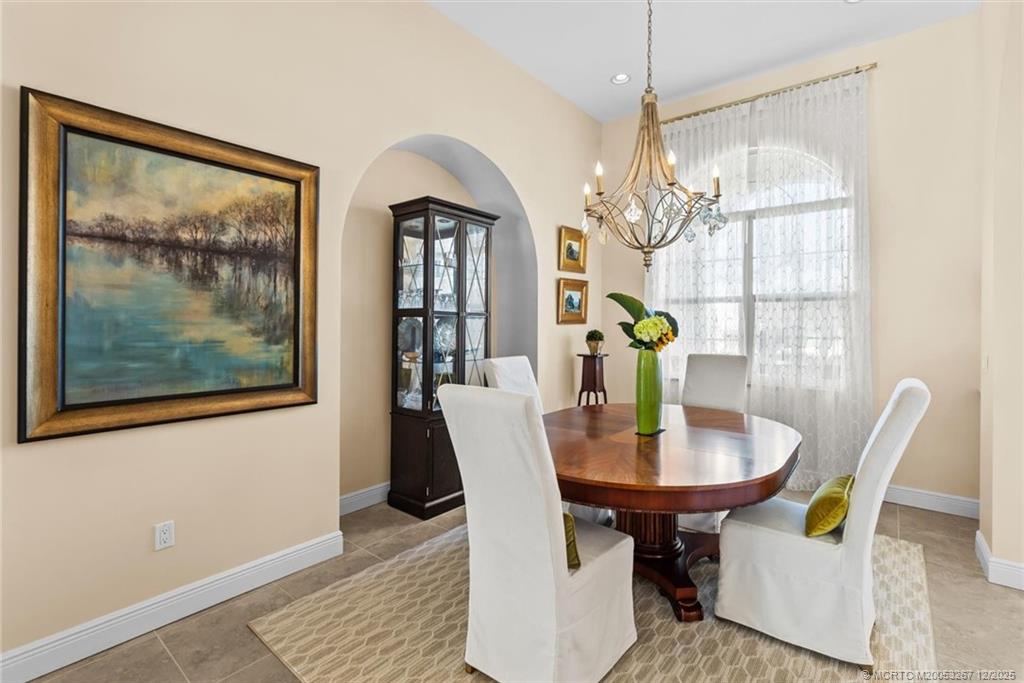 4940 Southeast Inlet Isle Way Stuart, FL 34997 - Photo 10 of 75 a view of a dining room with furniture and chandelier