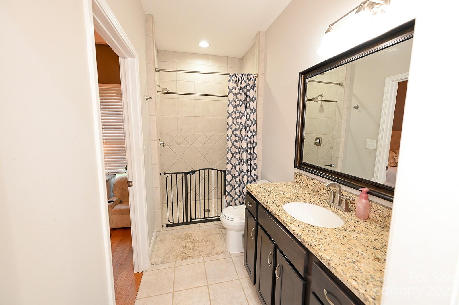 294 East High Road Bostic, NC 28018 - Photo 12 of 25 a bathroom with a granite countertop sink and a mirror