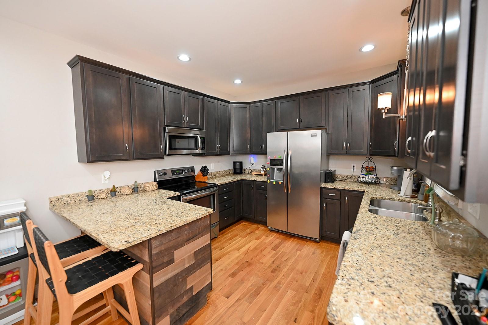 294 East High Road Bostic, NC 28018 - Photo 8 of 25 a kitchen with granite countertop stainless steel appliances and wooden cabinets