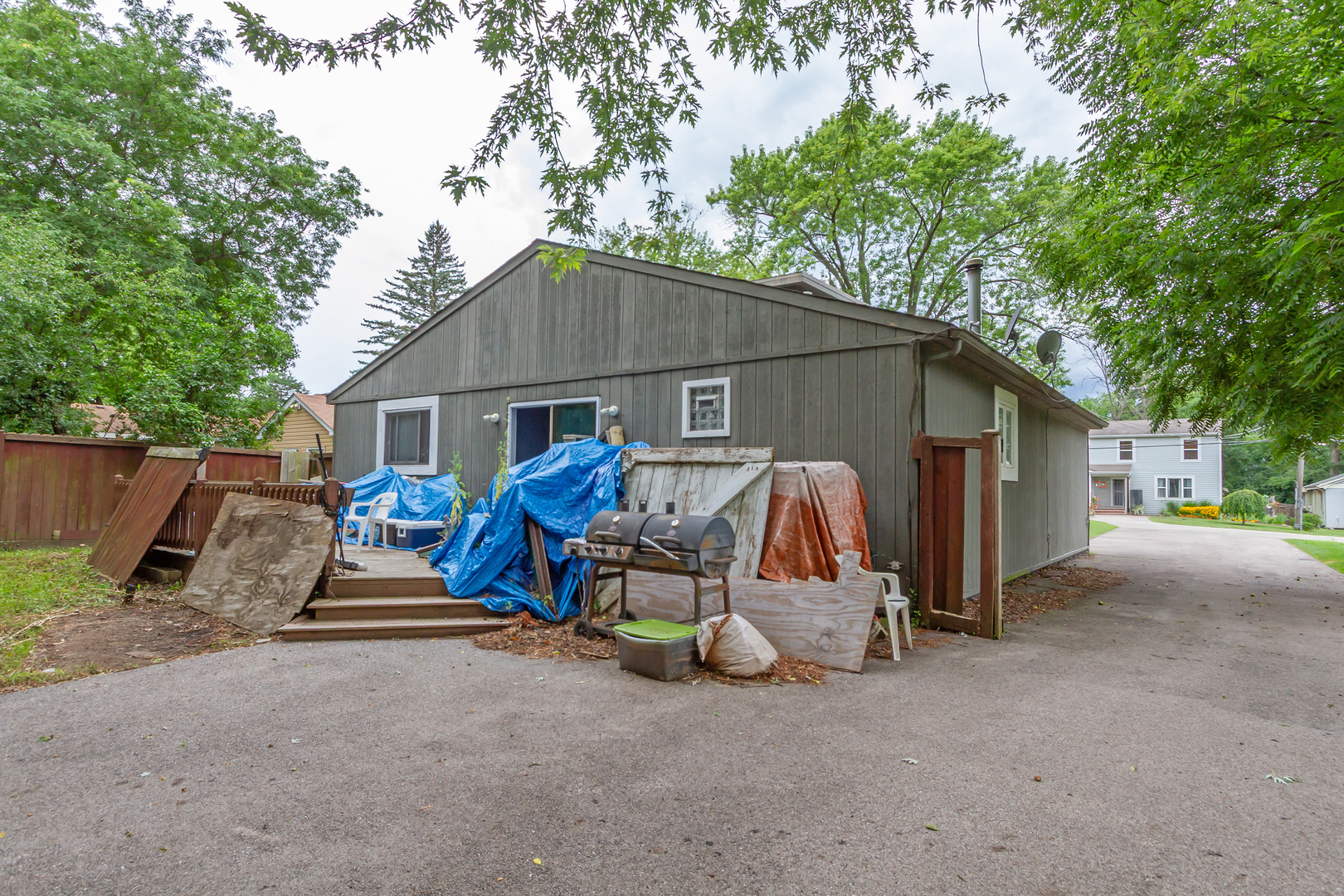 36379 Wesley Road Ingleside, IL 60041 - Photo 15 of 15 a view of a wooden house with large trees and playing area