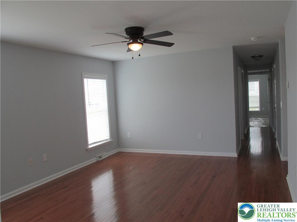 3813 Belcourt Road Easton, PA 18040 - Photo 6 of 25 a view of an empty room with wooden floor and a window