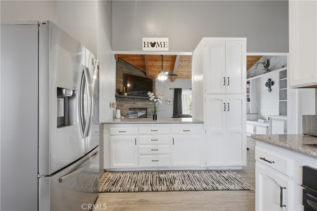 26201 Cumberland Road Tehachapi, CA 93561 - Photo 14 of 36 a kitchen with stainless steel appliances granite countertop a refrigerator and a sink