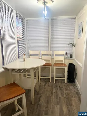 a kitchen with a table chairs sink and cabinets