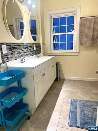 a bathroom with a double vanity sink and a mirror