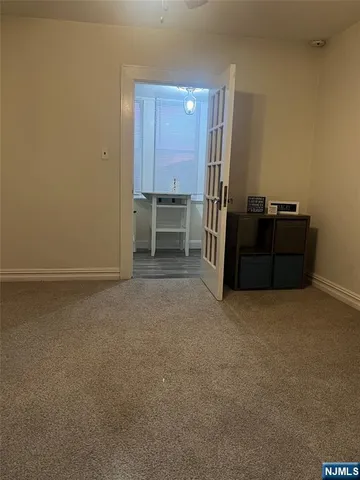 a view of an empty room with a cabinet