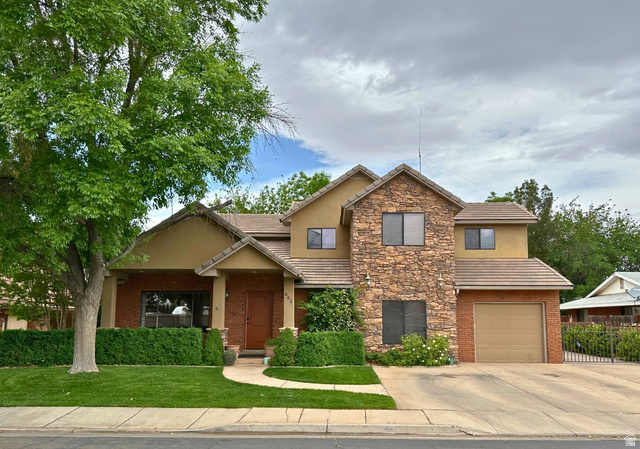 892 Cambridge Drive St. George, UT 84770 - Photo 1 of 65 Multi-level residence featuring a stone facade and stucco finishes