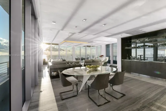 a living room with fireplace furniture and a large window