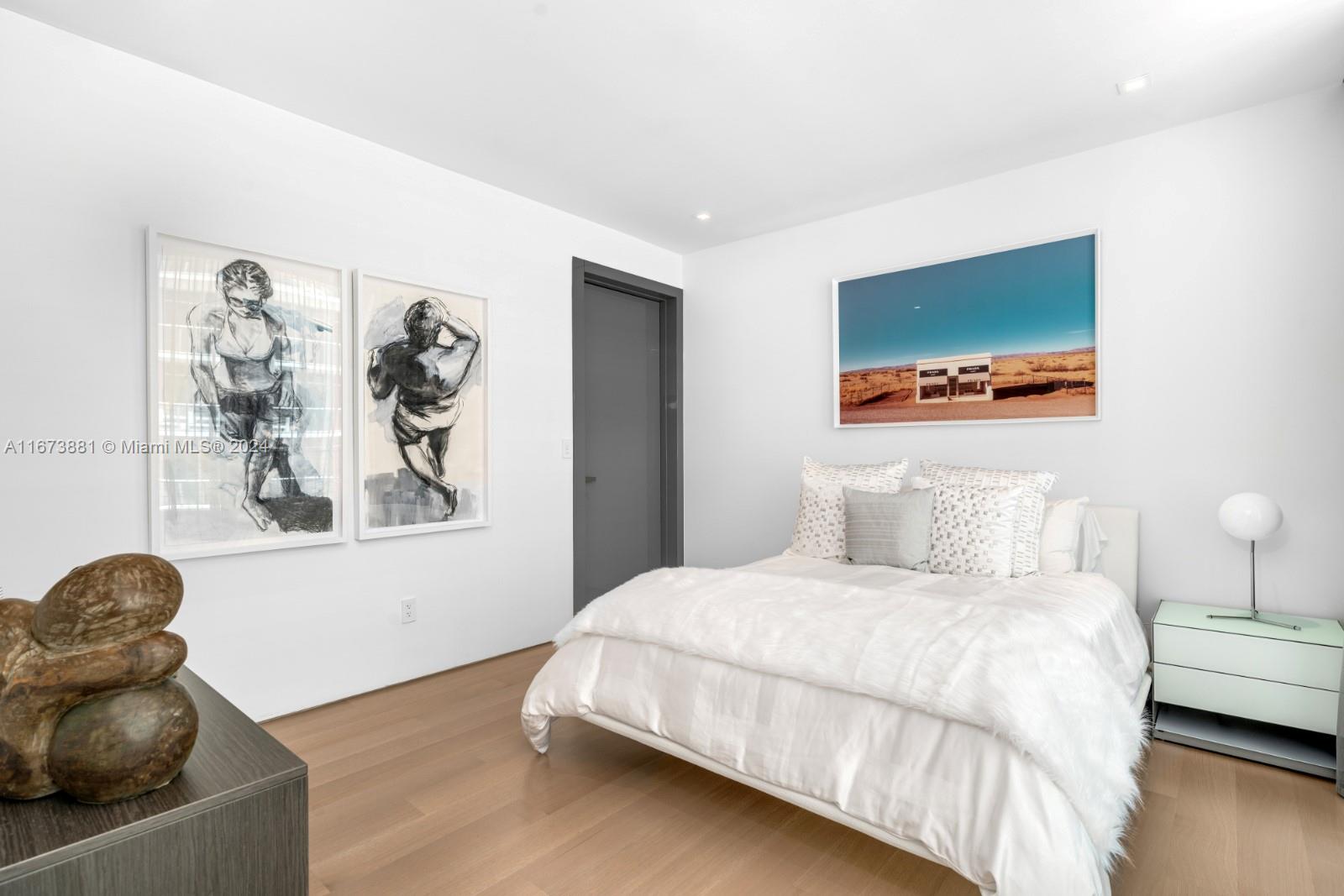 3651 Collins Avenue, Unit 800 Miami Beach, FL 33140 - Photo 23 of 33 a bedroom with a bed and painting on the wall