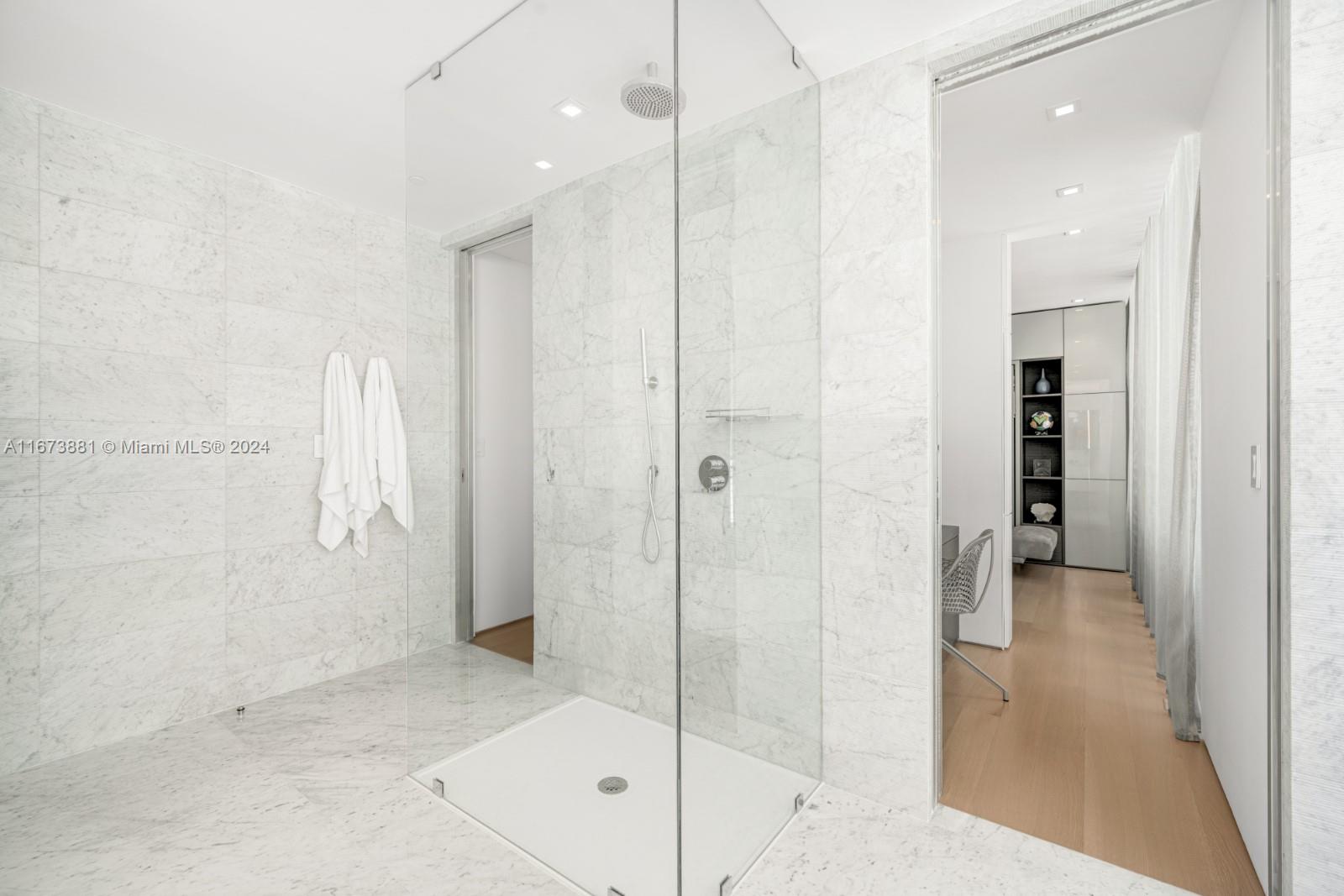 3651 Collins Avenue, Unit 800 Miami Beach, FL 33140 - Photo 27 of 33 a bathroom with a shower and a glass door