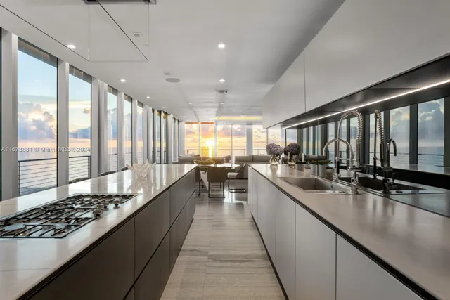 a large kitchen with lots of counter top space and living room
