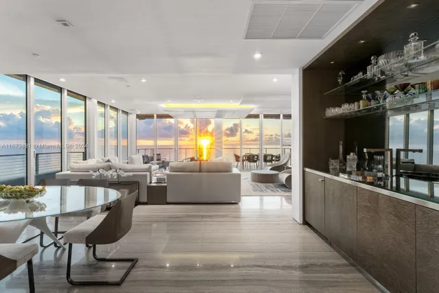 a large bedroom with a bed and large glass window