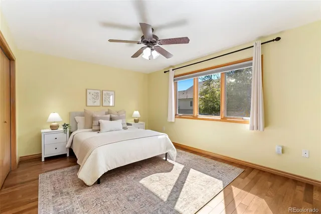a bathroom with a granite countertop sink a toilet and shower