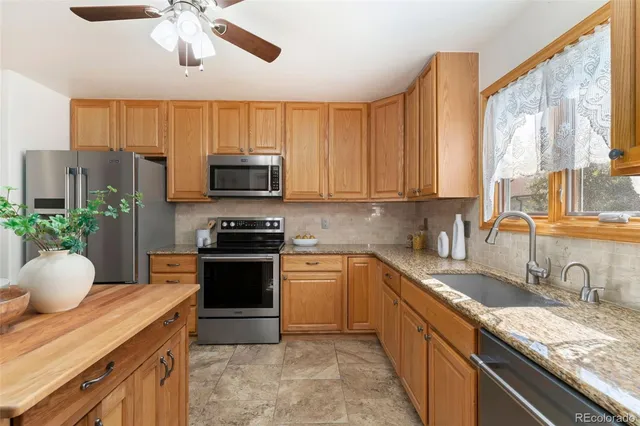 a bedroom with a bed lamp and a large window
