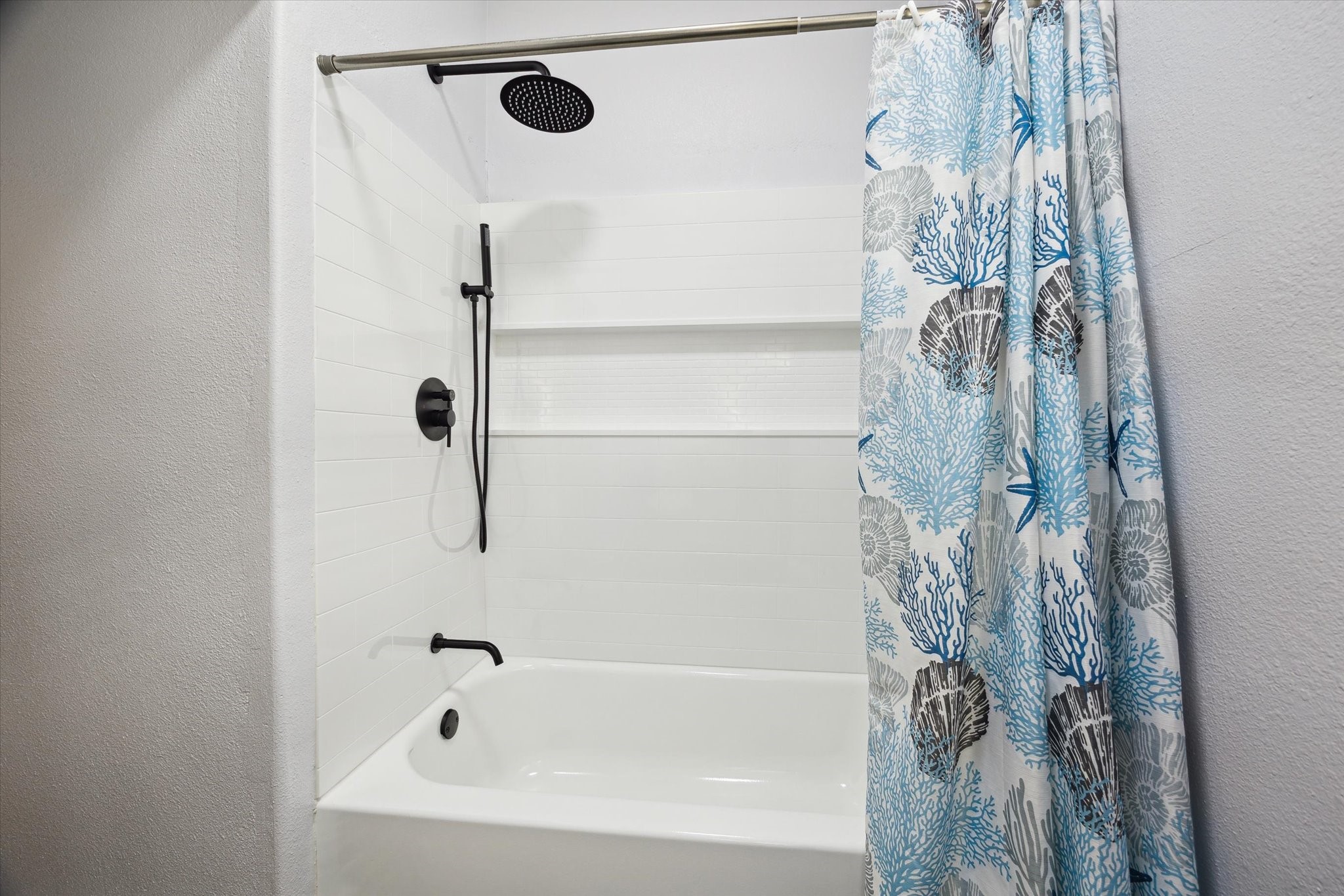 4109 Avenue R Galveston, TX 77550 - Photo 14 of 18 Experience luxury in the guest bathroom with a rain shower head and versatile handheld wand.