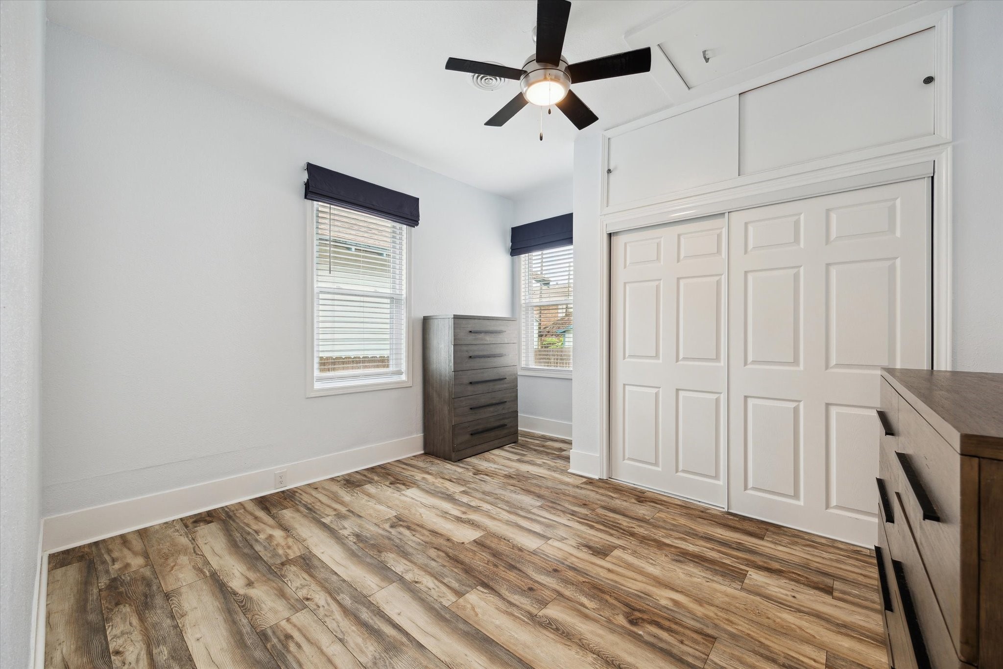 4109 Avenue R Galveston, TX 77550 - Photo 16 of 18 Spacious second bedroom with ample room for furnishings and a large closet featuring extra overhead storage.