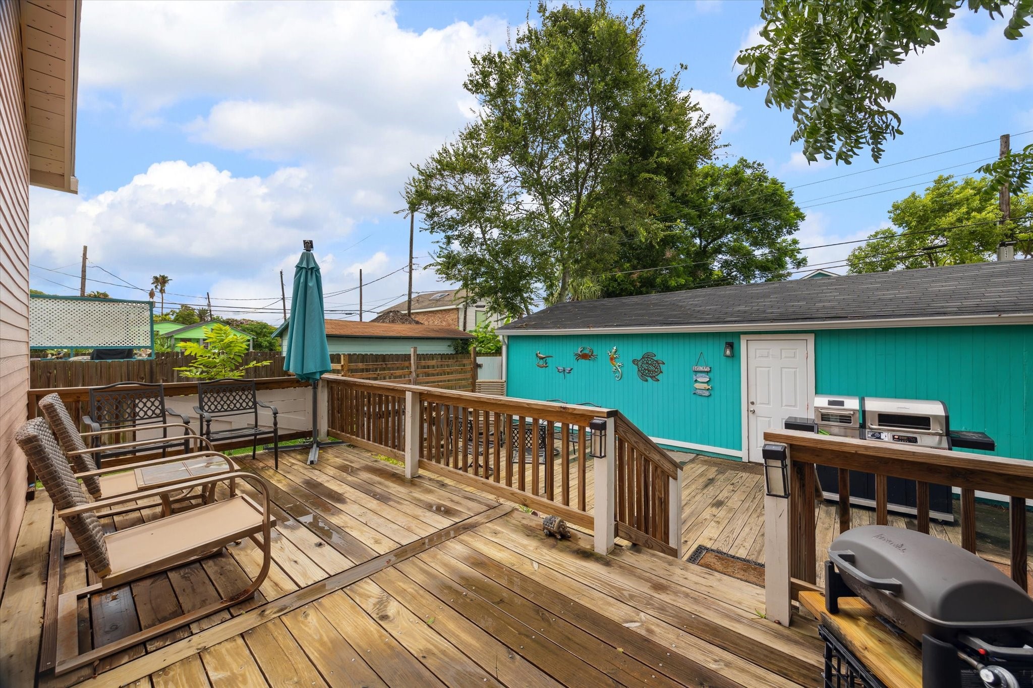 4109 Avenue R Galveston, TX 77550 - Photo 17 of 18 Enjoy spacious backyard entertaining with convenient garage/storage access—perfect for BBQs and relaxing in the afternoon breeze.