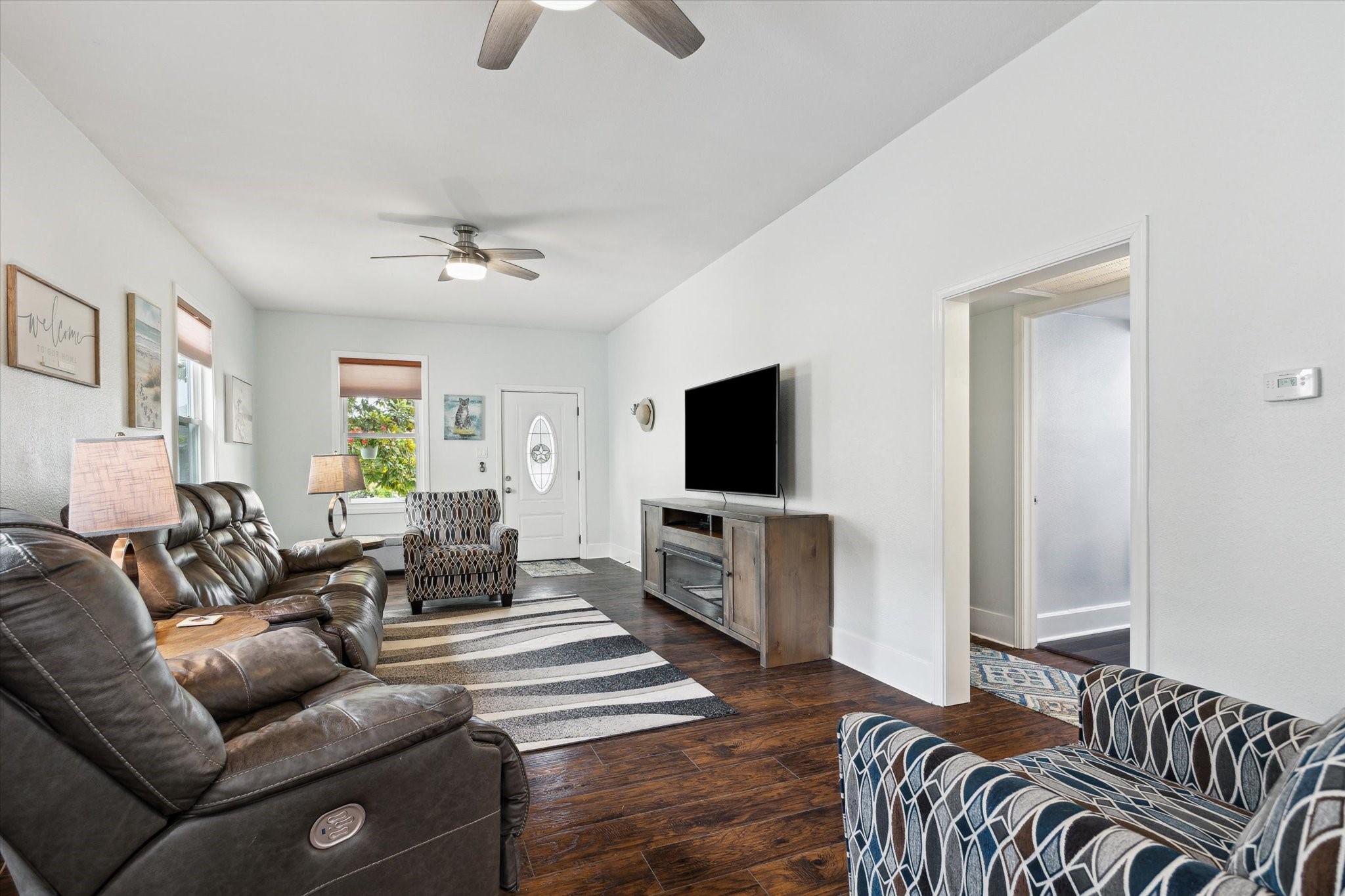 4109 Avenue R Galveston, TX 77550 - Photo 5 of 18 This inviting living room is bathed in natural light, creating a spacious and airy atmosphere.