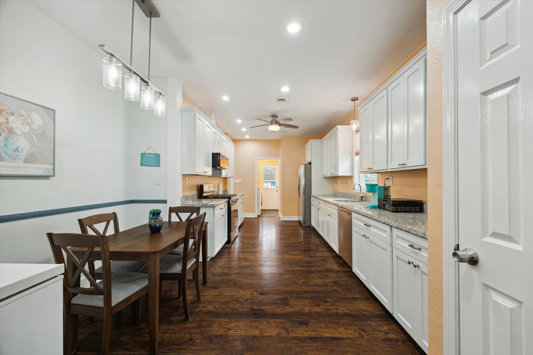 4109 Avenue R Galveston, TX 77550 - Photo 6 of 18 This recently updated kitchen boasts granite countertops, ample cabinets, and a charming dining area.