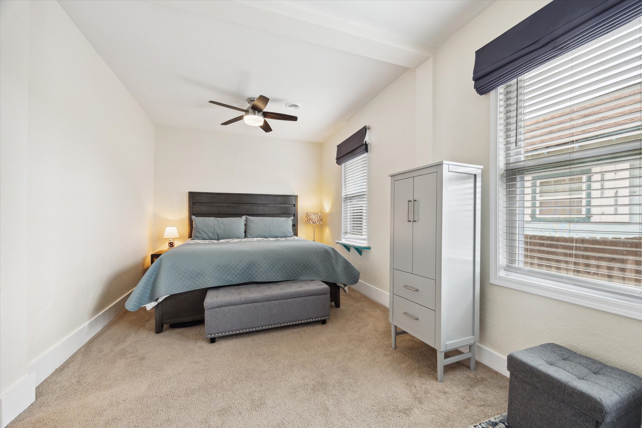 4109 Avenue R Galveston, TX 77550 - Photo 7 of 18 Discover a spacious primary bedroom retreat at the home's rear, bathed in natural light from large windows.