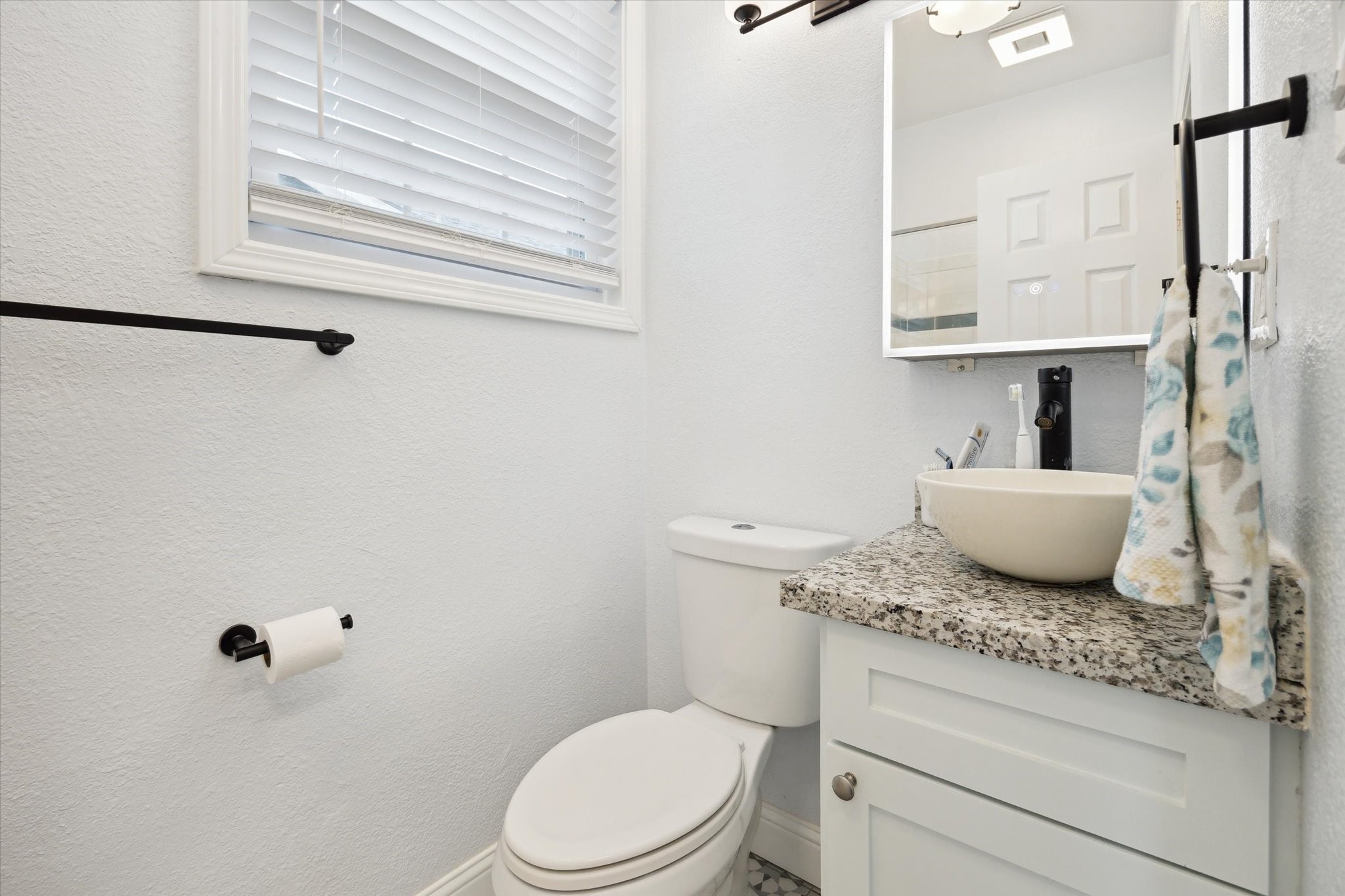 4109 Avenue R Galveston, TX 77550 - Photo 9 of 18 Discover the charm of this beautifully updated bathroom, featuring a stylish vessel sink and modern fixtures.