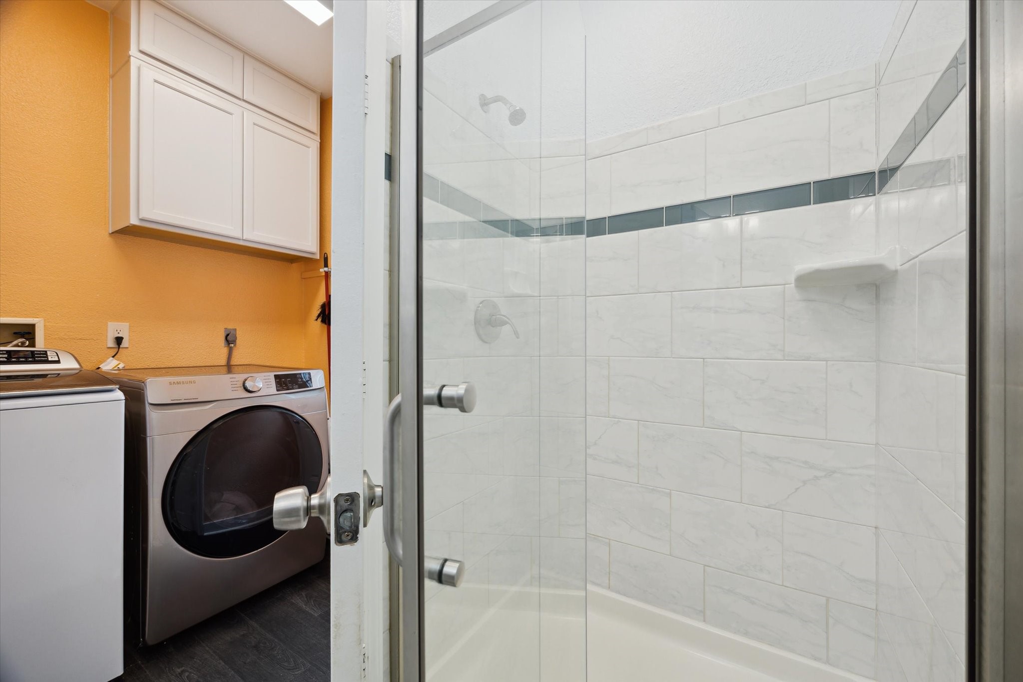 4109 Avenue R Galveston, TX 77550 - Photo 10 of 18 Discover a spacious, elegantly tiled shower with convenient separation from the nearby laundry area.