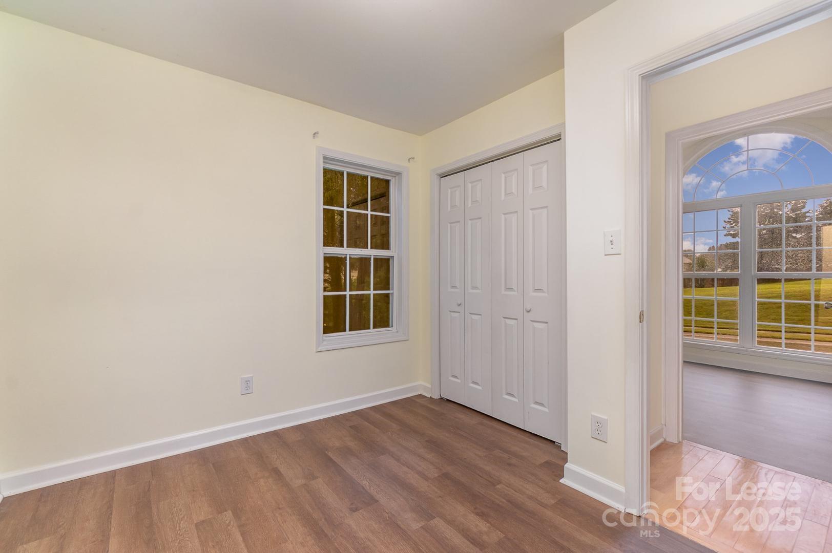 2716 Rabbit Ridge Drive Bessemer City, NC 28016 - Photo 12 of 15 an empty room with wooden floor and windows