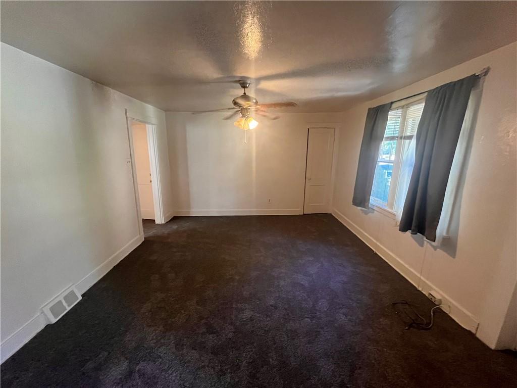 460 Reed Street, Unit 2L Pittsburgh, PA 15221 - Photo 4 of 13 an empty room with windows and fan