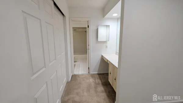 a view of hallway with wooden floor