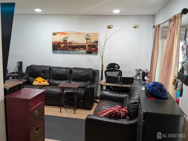 a living room with furniture a couch and a window