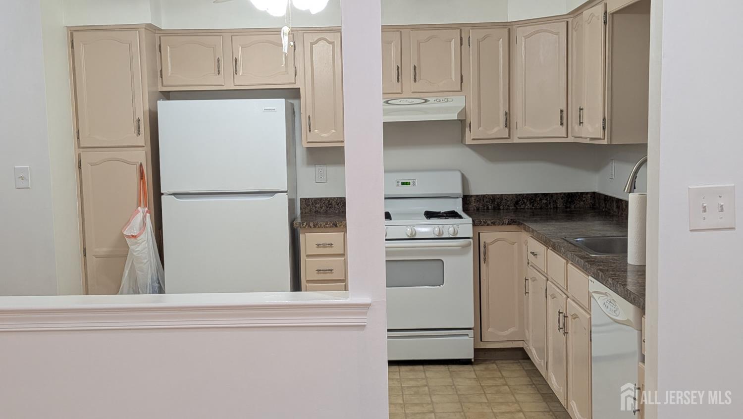 2103 Timber Oaks Road Edison, NJ 08820 - Photo 6 of 14 a kitchen with white cabinets and white appliances