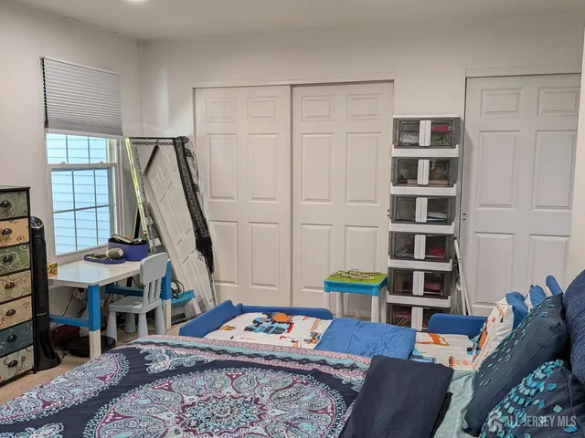 a bed room with a bed and a television