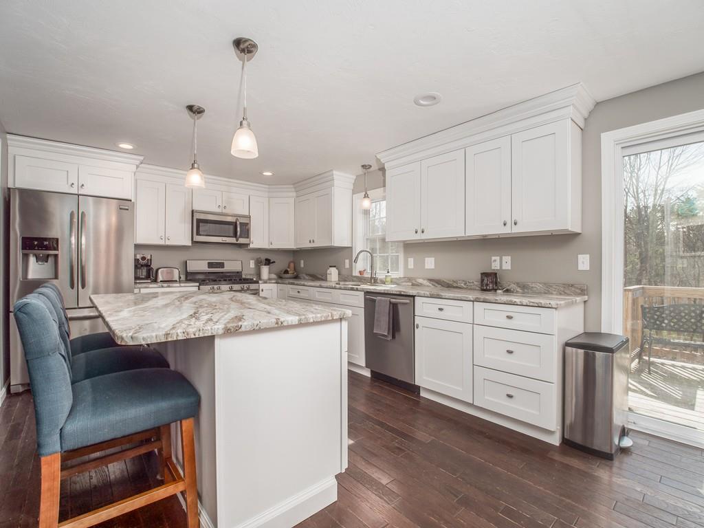 120 Erickson Road Ashby, MA 01431 - Photo 23 of 41 a kitchen with kitchen island granite countertop a sink cabinets and wooden floor